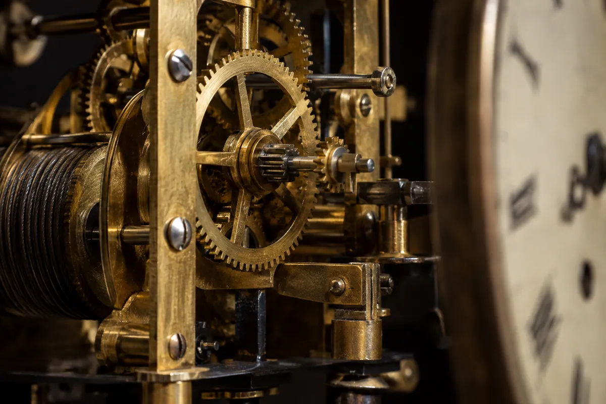 Brass gears and steel components inside a mechanical clock movement