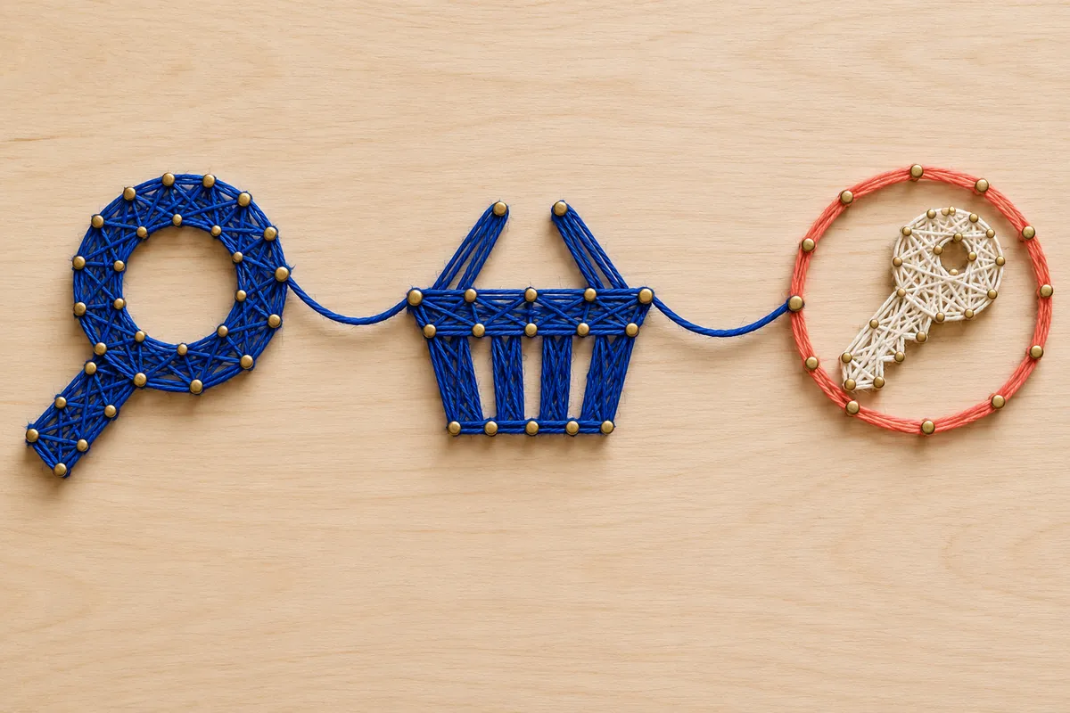 Thread shapes of a magnifying glass, basket and key are linked across a pale wooden board